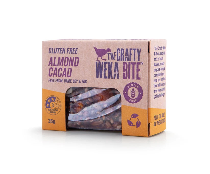 Crafty Weka gluten-free snack bars with almond and cacao flavor, displayed in a box, angled view showing packaging and product details.