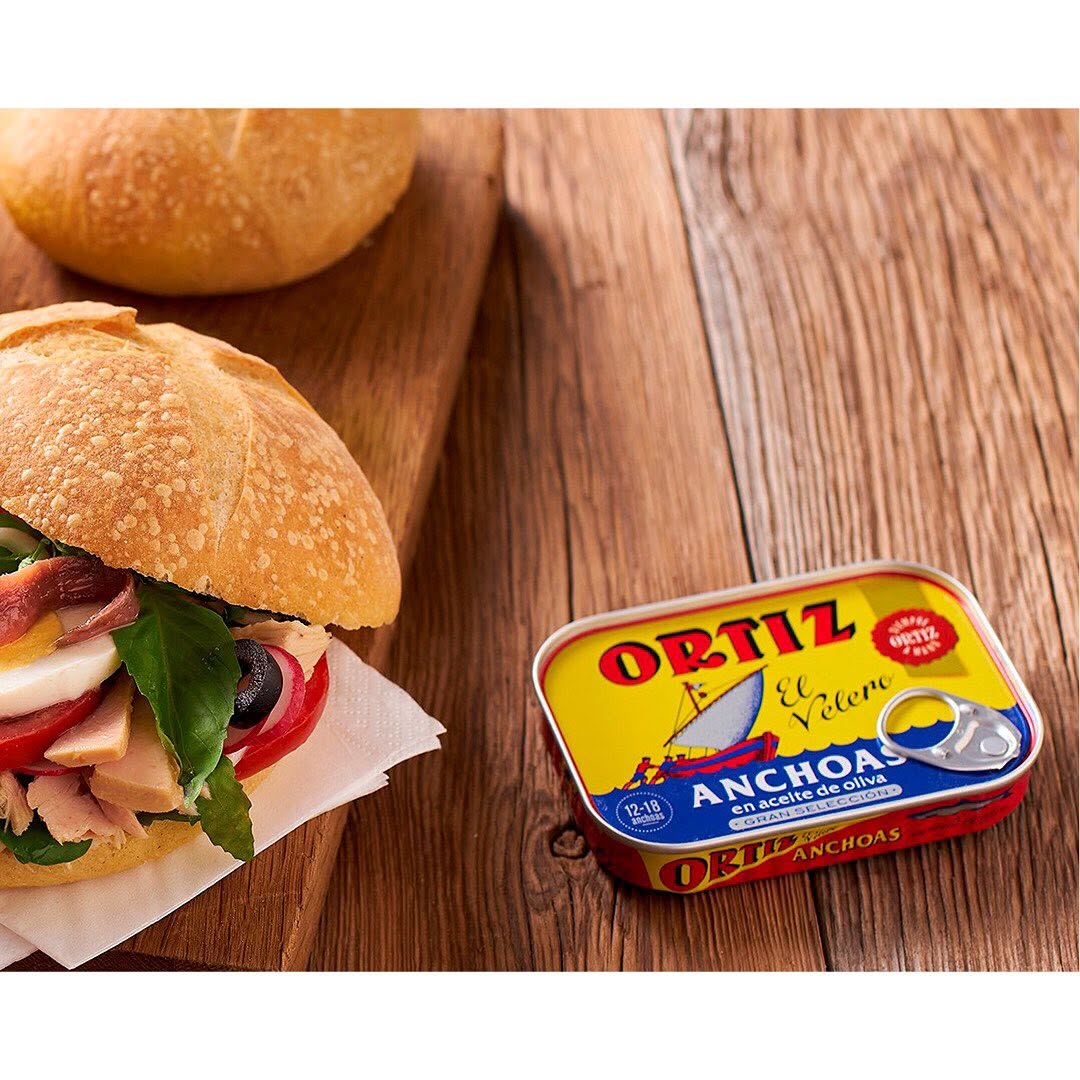 Canned Ortiz sardines in 140g tin, showing the fish packed in oil with a label featuring Ortiz branding and product details.