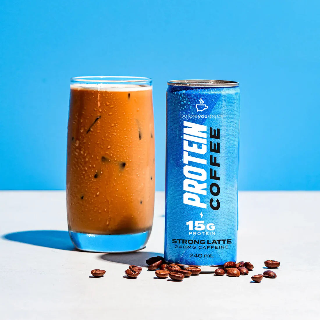 Cans of BEFORE YOU SPEAK Protein Latte Strong Latte in a 12-pack, showcasing the coffee beverage with branding and packaging.